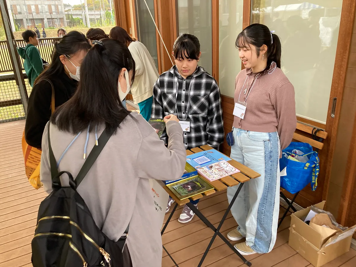 イラスト冊子の配布とペット利用の問題を説明する学生